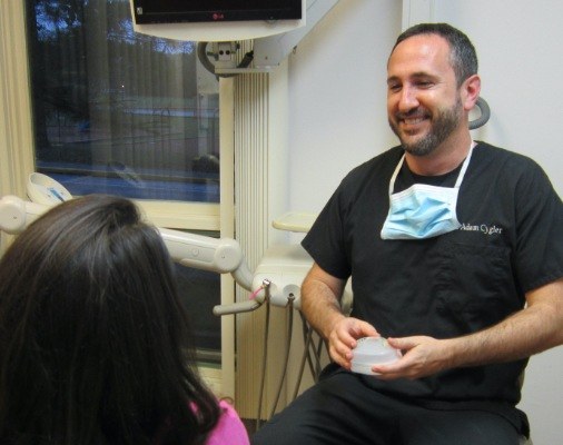 Dentist talking to dental patient