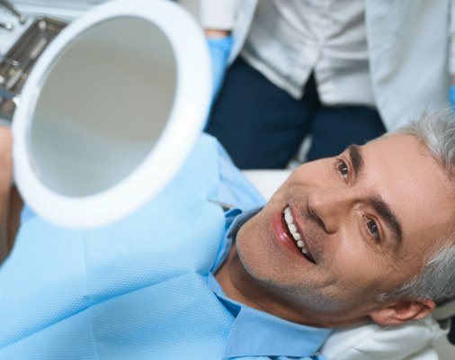 Patient looking at smile after teeth cleaning