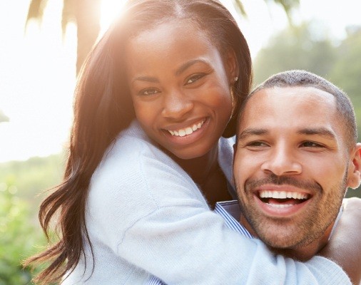 Man and woman with healthy smiles thanks to preventive dentistry