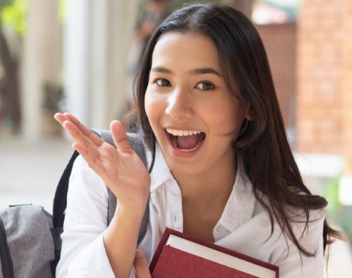 Woman showing off smile with metal free dental crown