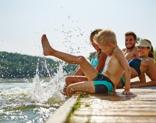 Family smiling on a dock