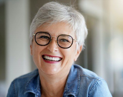Woman with dentures sharing flawless smile