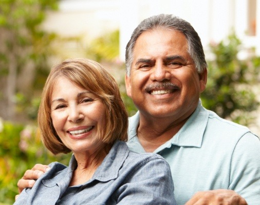 Man and woman with dentures smiling