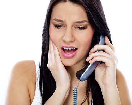 Woman with toothache calling her Mt. Holly emergency dentist