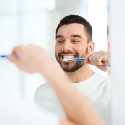 man brushing his teeth