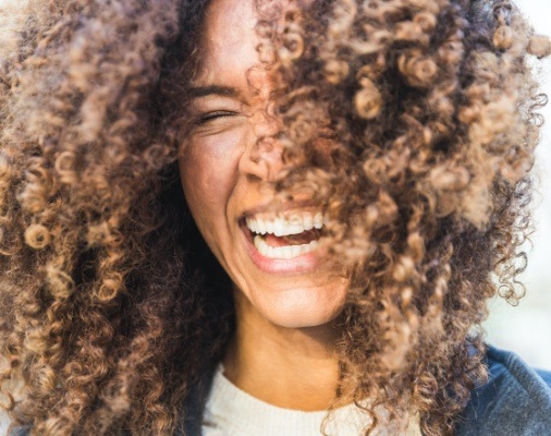 Woman with beautiful smile after tooth colored fillings