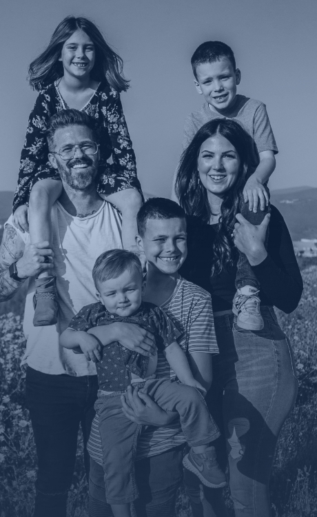 Family of six smiling together outdoors