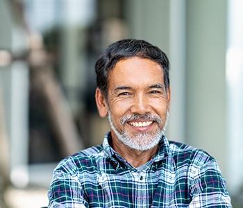 man smiling after getting dental implants in Mt Holly