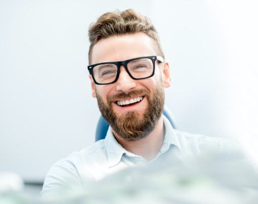 Man in dental chair smiling