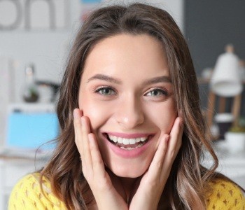 Woman showing off smile after Invisalign treatment