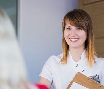 Dental team member discussing Invisalign payment options