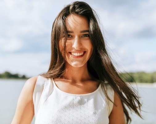 Woman with gorgeous smile after Invisalign treatment