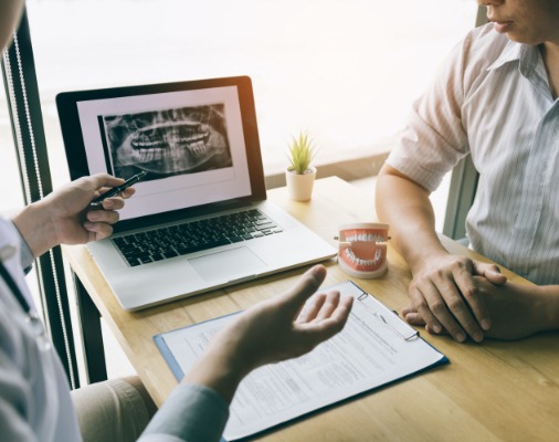 Dentist and patient reviewing periodontal charting and diagnostics