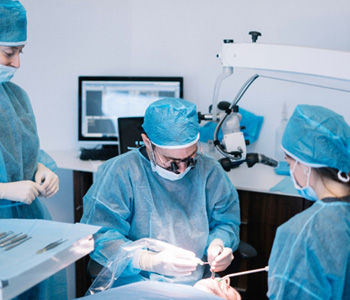 Dentists performing a dental implant surgery