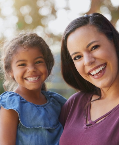 Mother and daughter smiling after children's dentistry visit