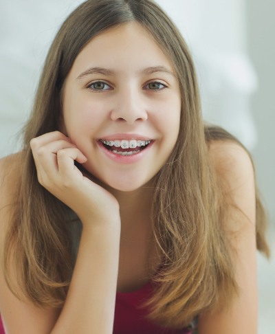 Smiling young woman with braces