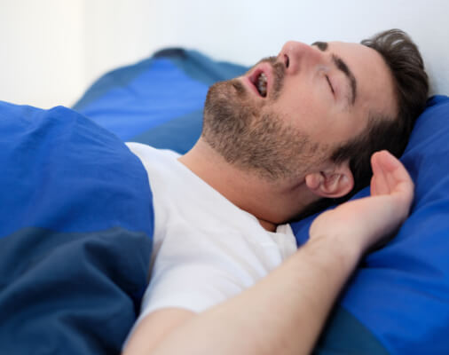 Snoring man in need of sleep apnea treatment