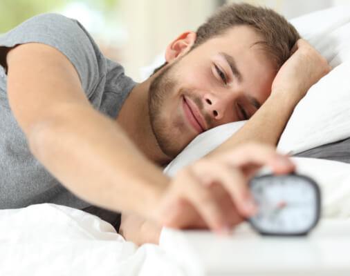 Man waking rested after sleep apnea treatment