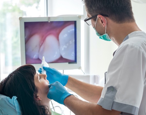 Dentist using intraoral camera to capture smile images