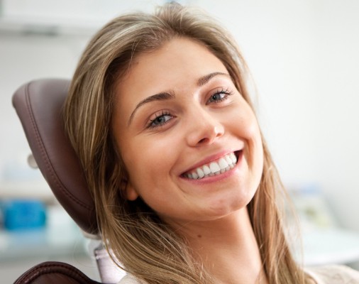 Woman smiling during porcelain veneer process