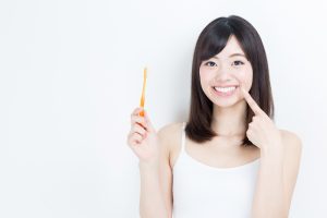 woman with toothbrush and beautiful smile