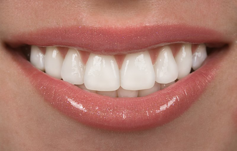 A person with straight teeth smiling.