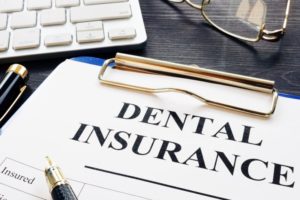 Clipboard with paperwork on how to maximize dental insurance benefits