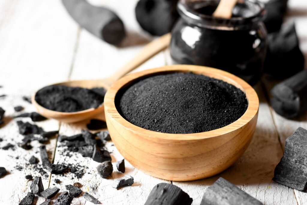Activated charcoal in wooden bowl