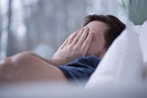 man drowsy from poor sleep