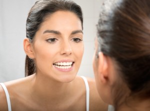 woman looking at teeth for signs of gum disease mt Holly residents trust the mt holly family dentistry team for treatment and prevention of gum diseae